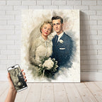 Custom wedding anniversary watercolor wall art by Ausome Love Studio, showing a colorized restoration of a vintage bride and groom photo printed on a large canvas, with the original black and white photo displayed on a smartphone.