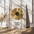 Personalised couple print with a gold vinyl record on a cream background, featuring five sense-themed love messages and line-art faces, the names Charlotte & Oliver and the date 09.07.2011 below, in a white frame.