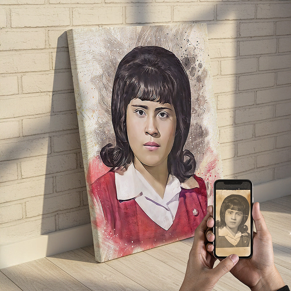 Custom woman’s portrait watercolor wall art by Ausome Love Studio, featuring a colorized restoration of a vintage 1960s photo on a large canvas leaning against a brick wall, with the original sepia photo shown on a smartphone.