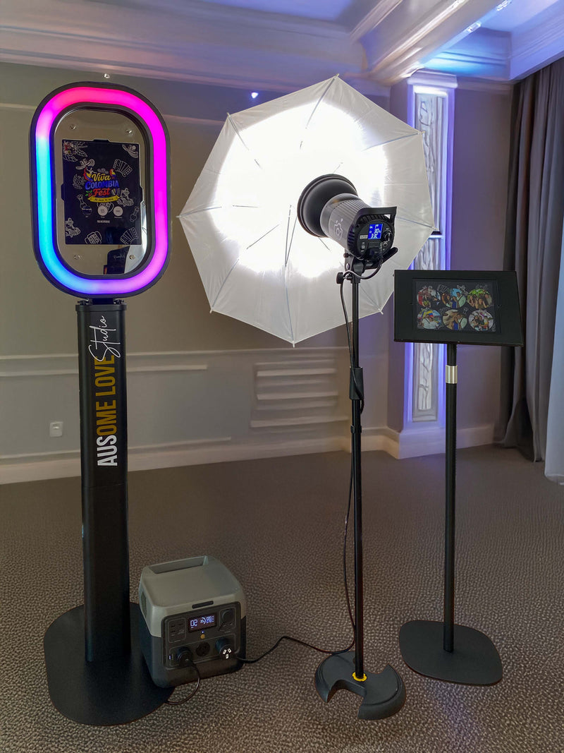 An Ausome Love Studio selfie photo booth with a colourful LED ring light, professional umbrella lighting and a battery power pack, set up in an elegant venue