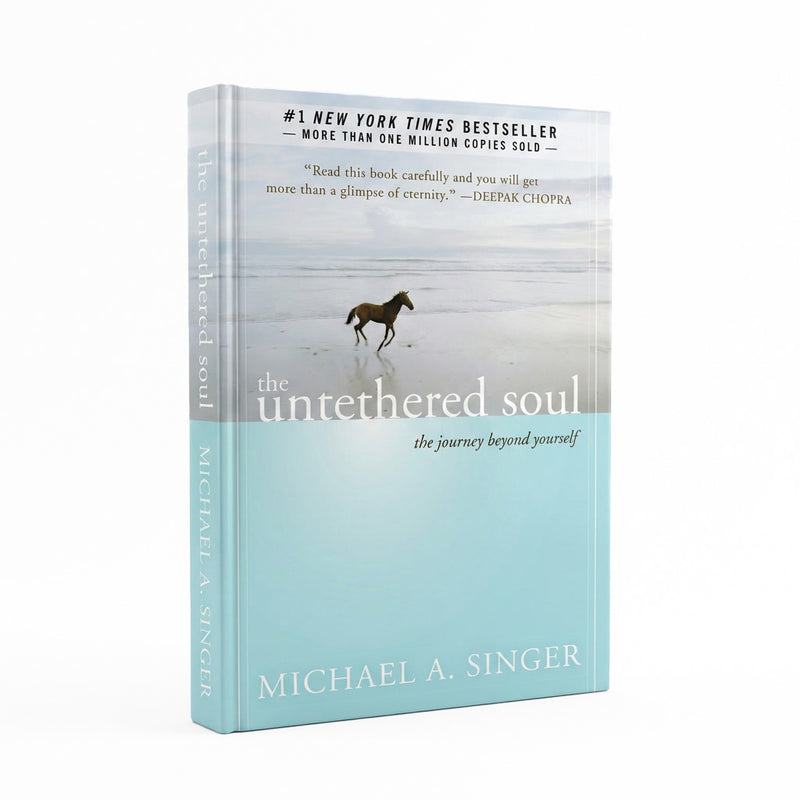 The unthreated soul: the journey beyond yourself book by Michael A. Singer, featuring a light blue and white cover with a horse running on a beach.