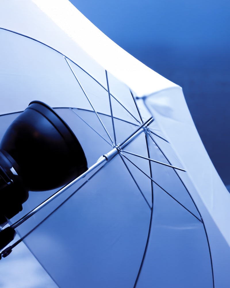 Close-up of a professional studio umbrella light against a blue background, the studio-quality lighting used at Ausome Love Studio photo booths