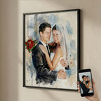Custom wedding portrait by Ausome Love Studio featuring a watercolor effect printed on wall art, showing a bride and groom in a black frame next to the original photo on a phone.